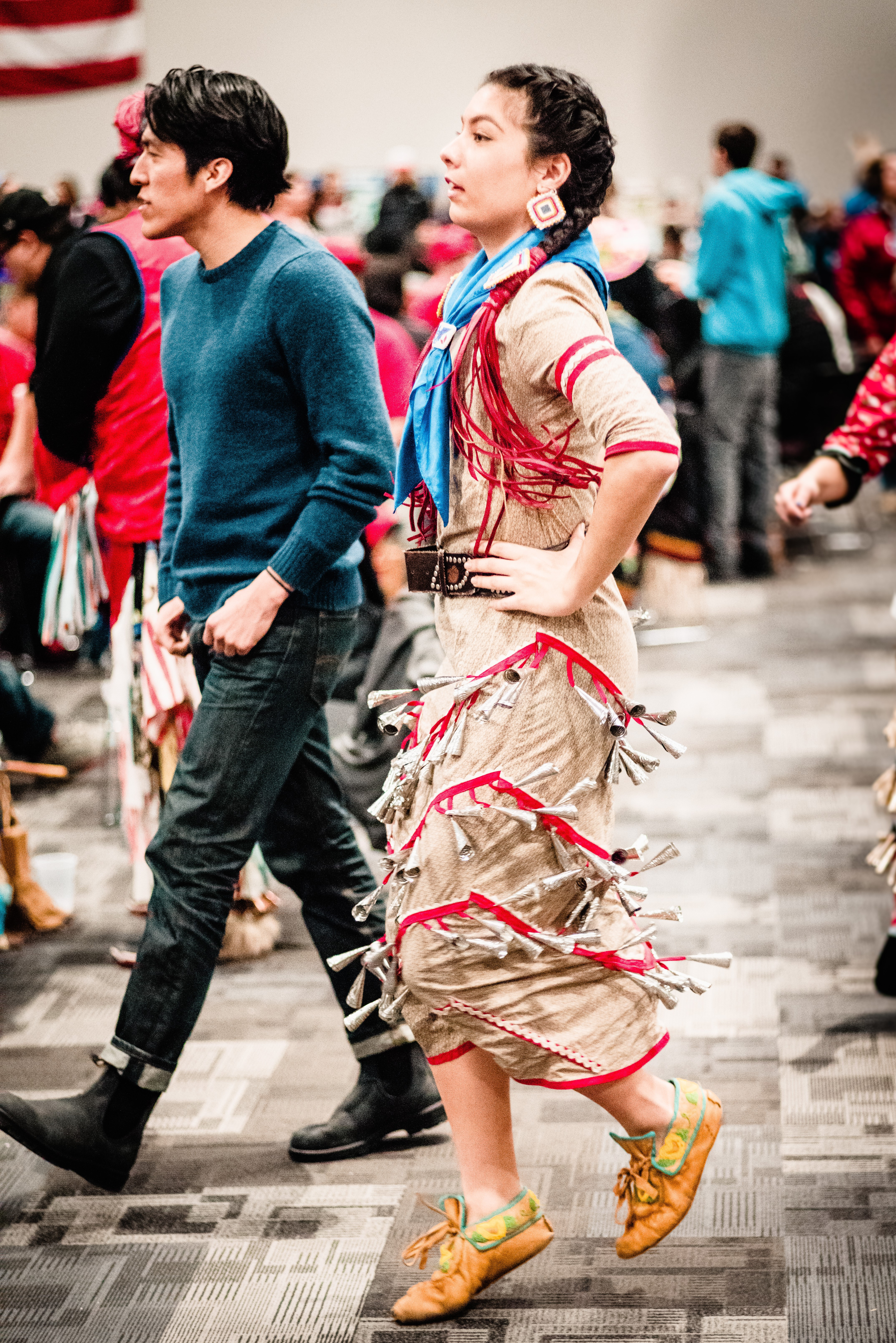 Two alumni walking at Fond Du Lac Pow Wow 2018