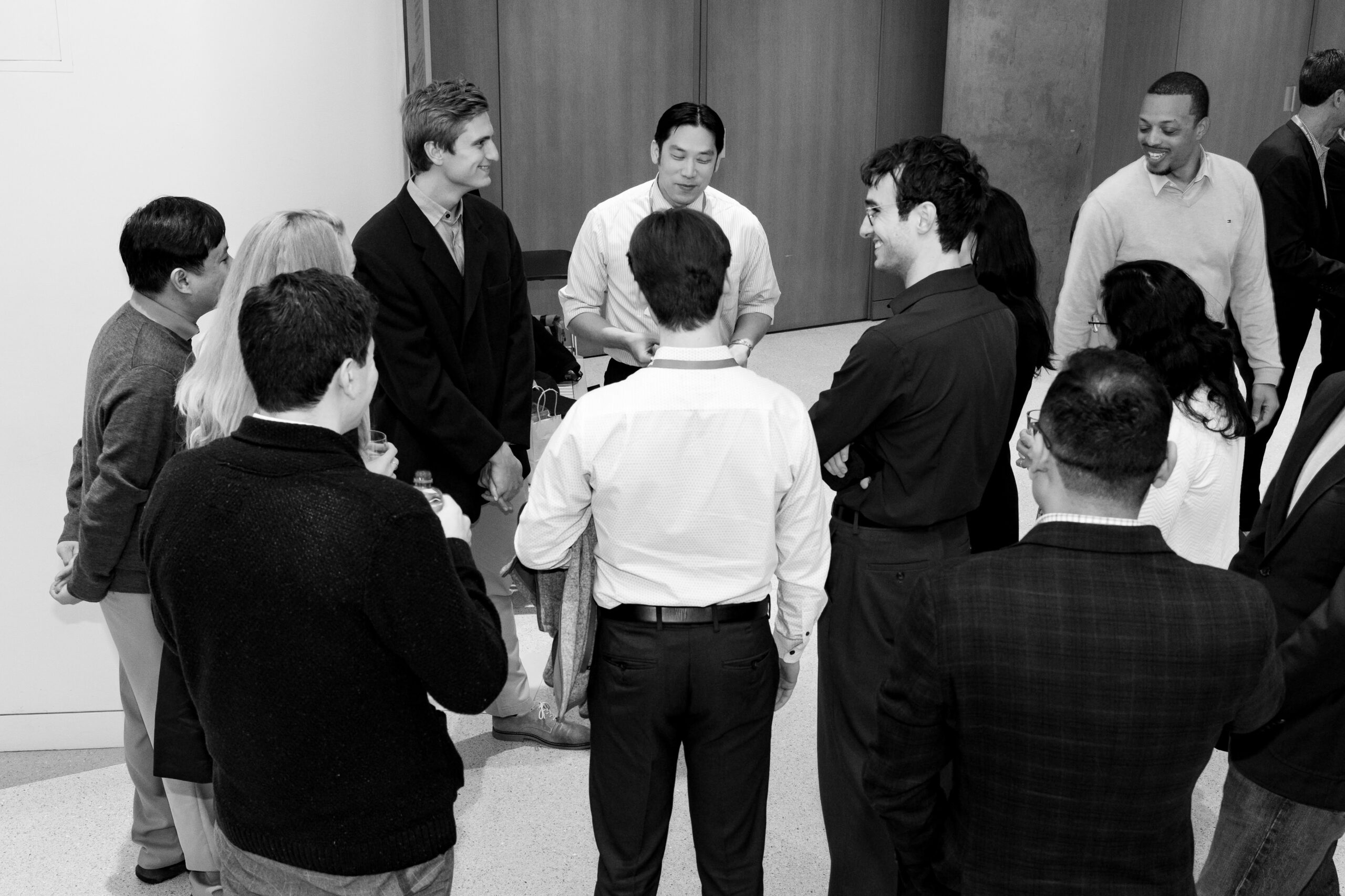 A group of conferees standing in a circle