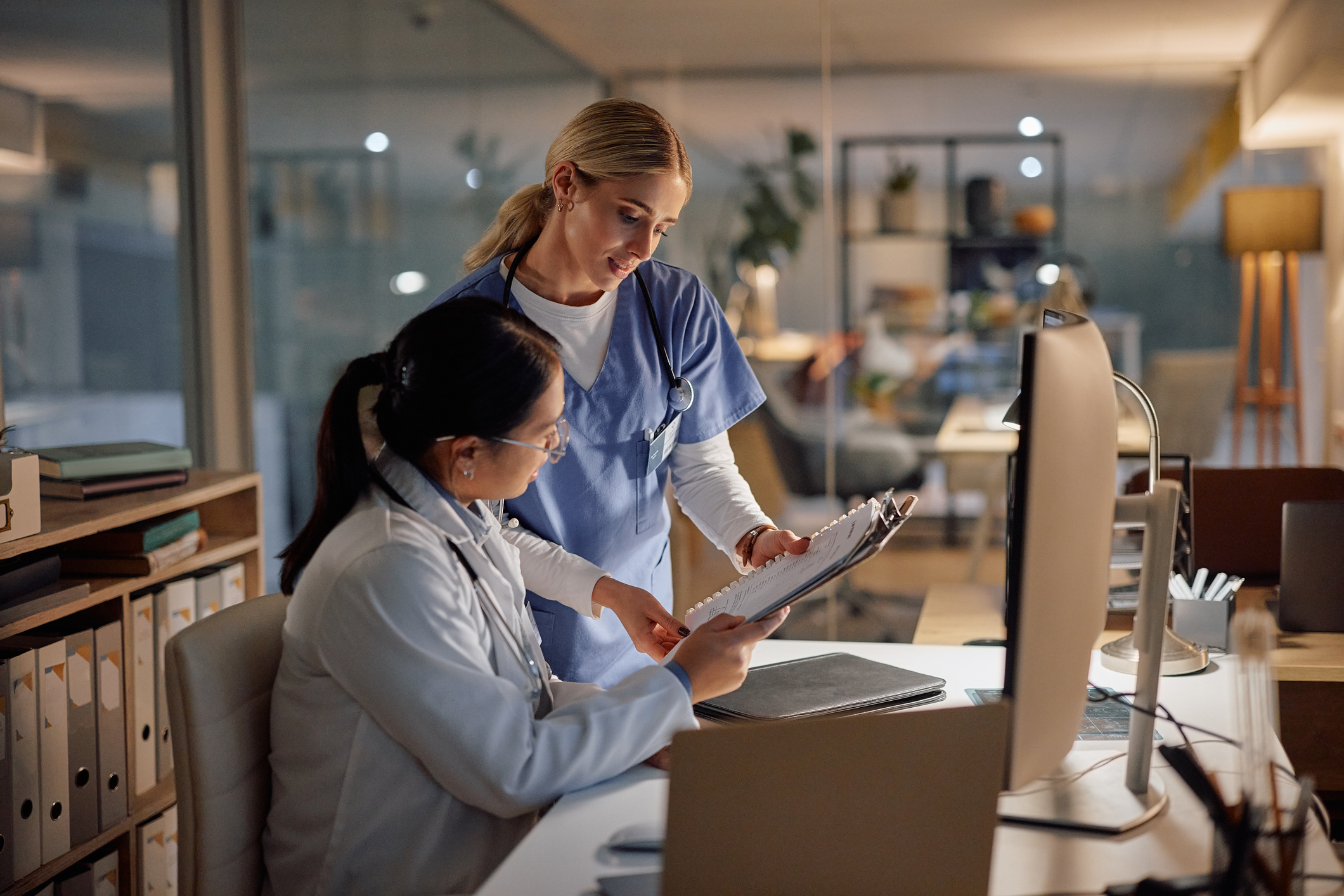 Two medical colleagues work late at night.
