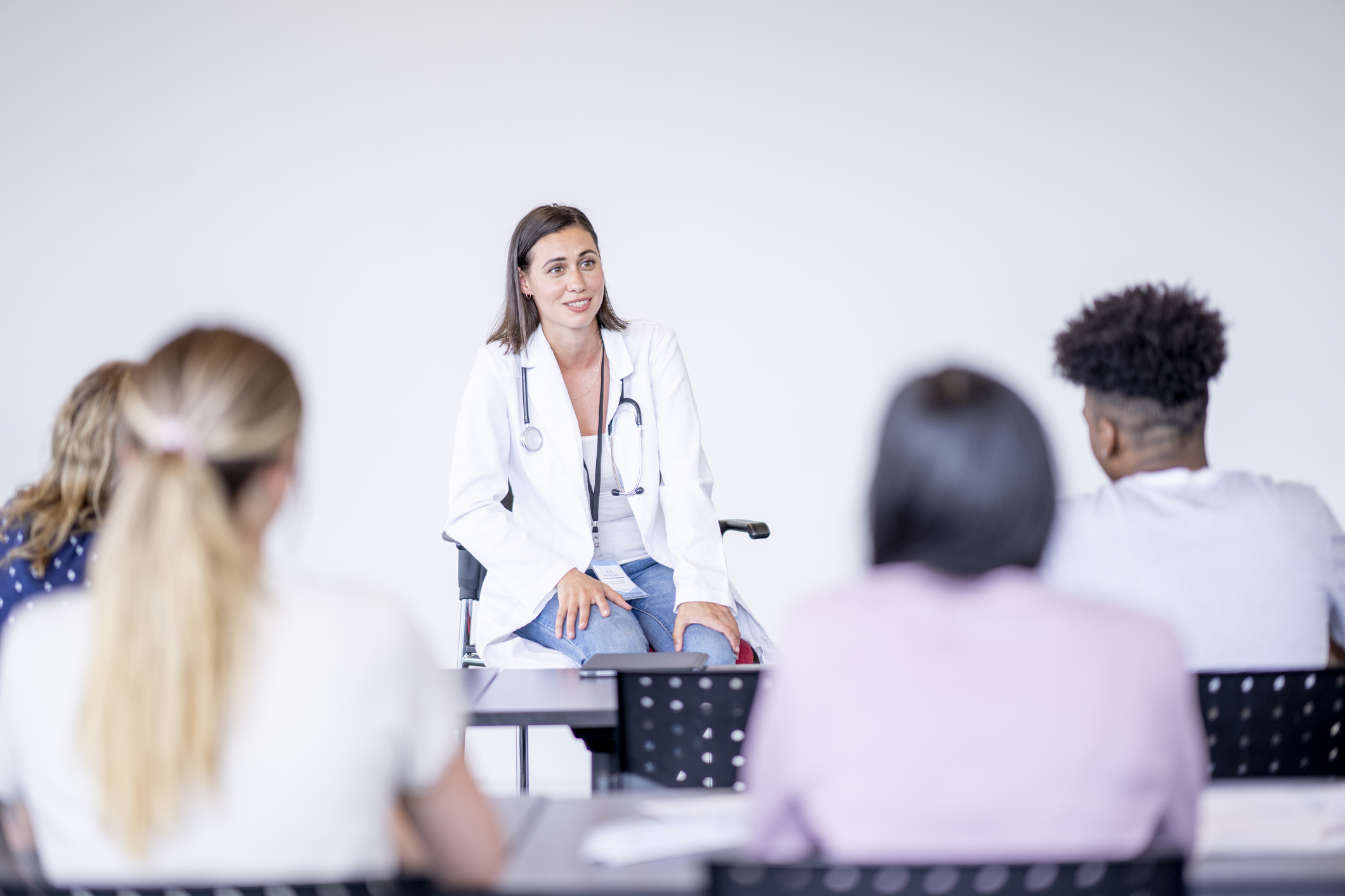 A medical professor teaches a group of students.